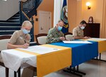 To recognize Domestic Violence Awareness Month, the commanders from Naval Medical Forces Atlantic (NMFL), Naval Medical Center Portsmouth (NMCP), and Naval Support Activity Hampton Roads (NSA HR) gave their signatures to proclaim October 2021 as Domestic Violence Awareness Month, in NMPC’s historic Bldg. 1 foyer, Oct. 6. From the left are Capt. Shelley Perkins, NMCP commanding officer; Rear Adm. Darin Via, NMFL commander; Capt. Matthew Frauenzimmer, NSA HR commanding officer.  Jessica Zimmer, Fleet & Family Support Center Norfolk Family Advocacy Program (FAP) Victim Advocate, hosted the proclamation signing.
