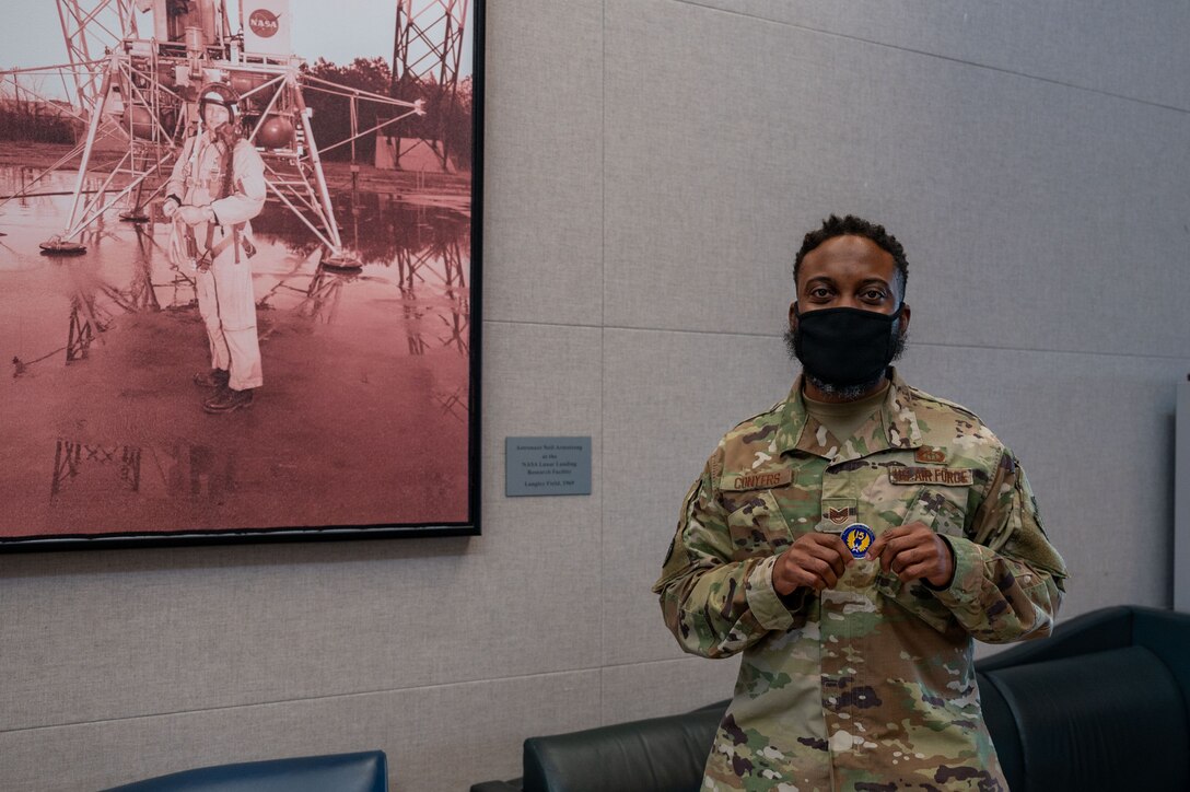 U.S. Air Force Tech. Sgt. Tyrome Conyers, 1st Operations Support Squadron weather flight non-commissioned officer in charge of mission services, poses with his Fifteenth Air Force coin at Joint Base Langley-Eustis, Virginia, Oct. 18, 2021.