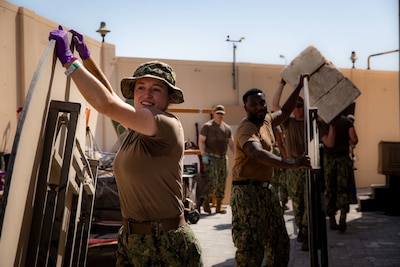 ISA TOWN, Bahrain (Oct. 16, 2021) Sailors assigned to U.S. Naval Forces Central Command and Coastguardsmen assigned to Patrol Forces Southwest Asia participate in a community relations (COMREL) event at Bahrain Mobility International (BMI) in Isa Town, Oct 16. During the COMREL, more than 80 participants from multiple commands volunteered to assist with cleanup efforts, beautification projects and interactive programs with children. (U.S. Army photo by Sgt. Thiem Huynh)