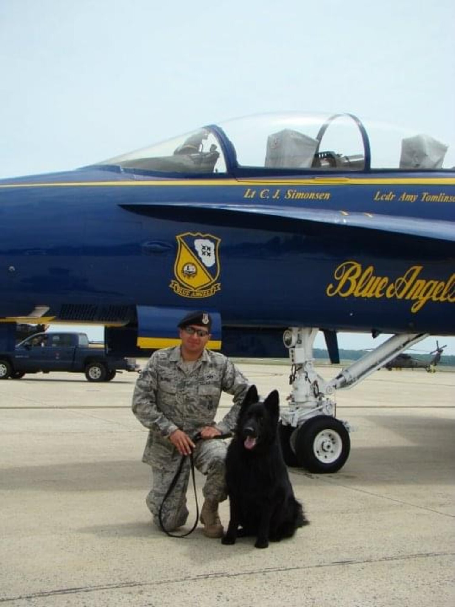 U.S. Air Force Tech. Sgt. Joseph Tejada, 30th Security Forces Squadron alpha flight sergeant, poses with Military Working Dog Sam in front of a Navy F/A-18E Super Hornet after doing a sweep of the pilots and crew on Andrews Air Force Base, Maryland. Sam and Tejada spent approximately 12 years of their life together and completed multiple deployments. (Courtesy photo by Tech. Sgt. Joseph Tejada)