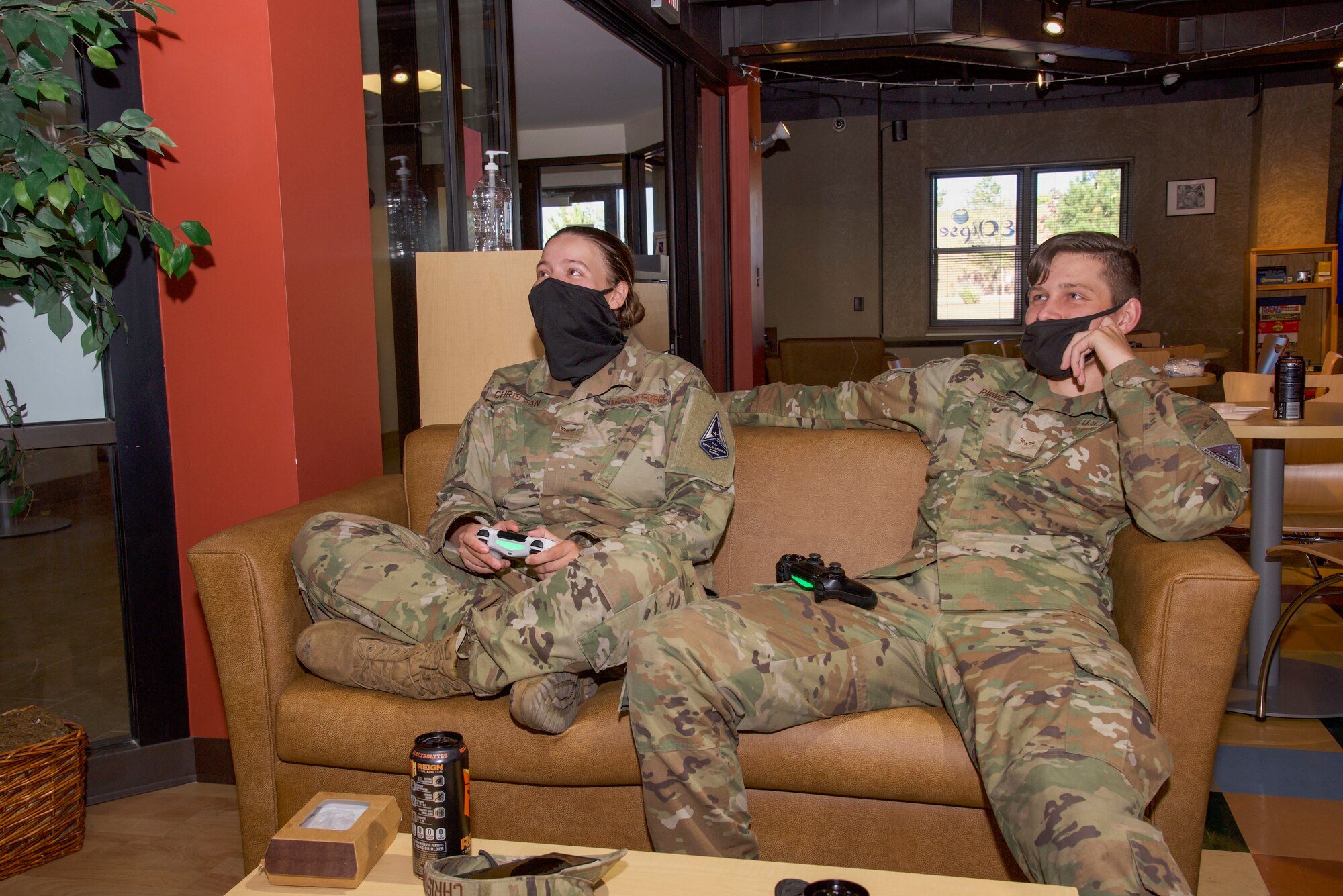 U.S. Air Force Airman 1st Class Alexis Christian and U.S. Air Force Airman 1st Class Ryan Prince, Peterson-Schriever Garrison Public Affairs mass communication specialists, play videogames at the Eclipse Café on Peterson Space Force Base, Colorado, Oct. 5, 2021.