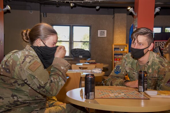 U.S. Air Force Airman 1st Class Alexis Christian and U.S. Air Force Airman 1st Class Ryan Prince, Peterson-Schriever Garrison Public Affairs mass communication specialists, play Scrabble at the Eclipse Café on Peterson Space Force Base, Colorado, Oct. 5, 2021.