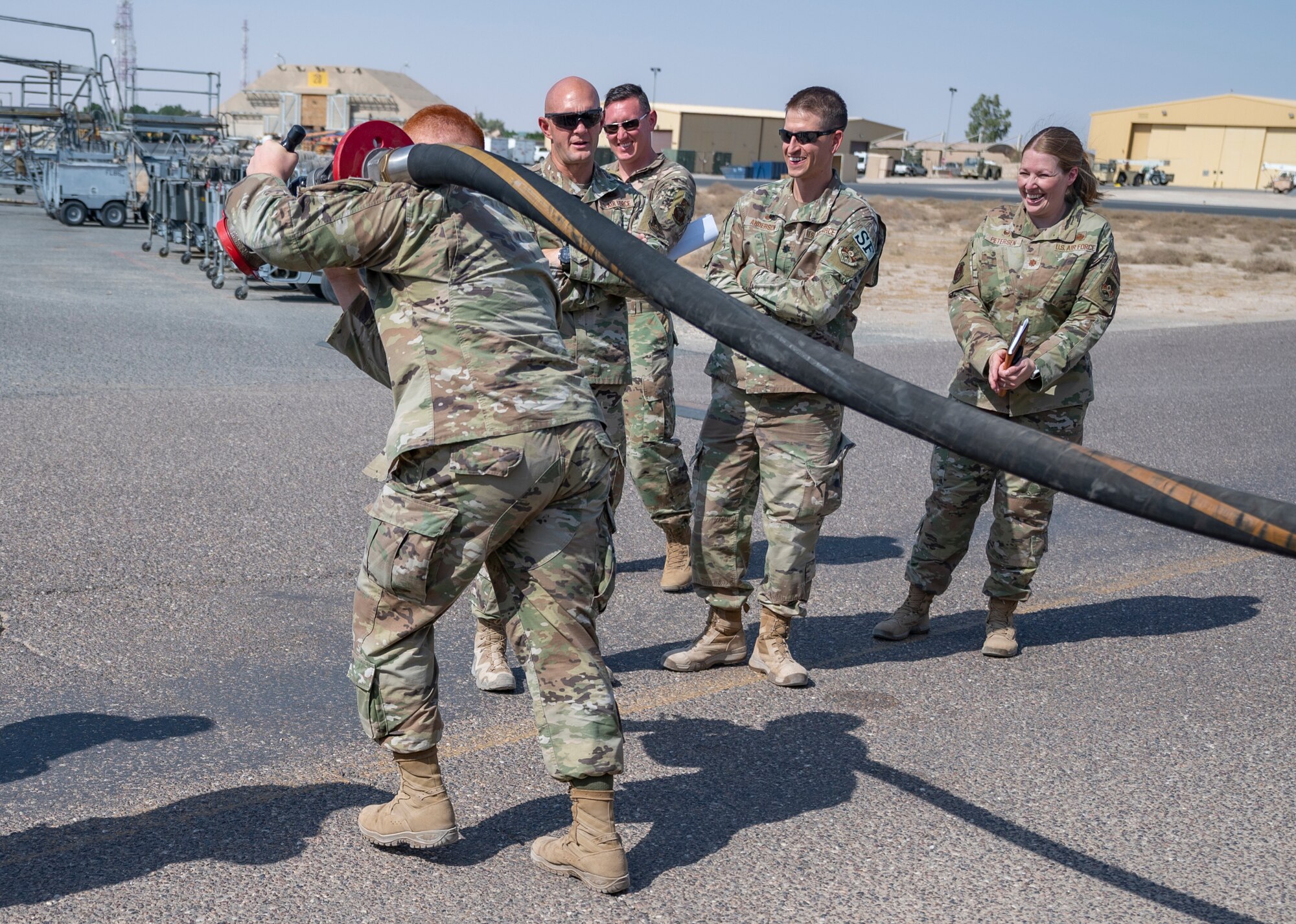 U.S. Air Force Staff Sgt. Leonardo Meza Camarena, a budget analyst assigned to the 386th Air Expeditionary Wing Financial Management Office, performs a hose pull from a 386th Expeditionary Logistics Readiness Squadron fuel truck at Ali Al Salem Air Base, Kuwait, on Oct. 15, 2021.