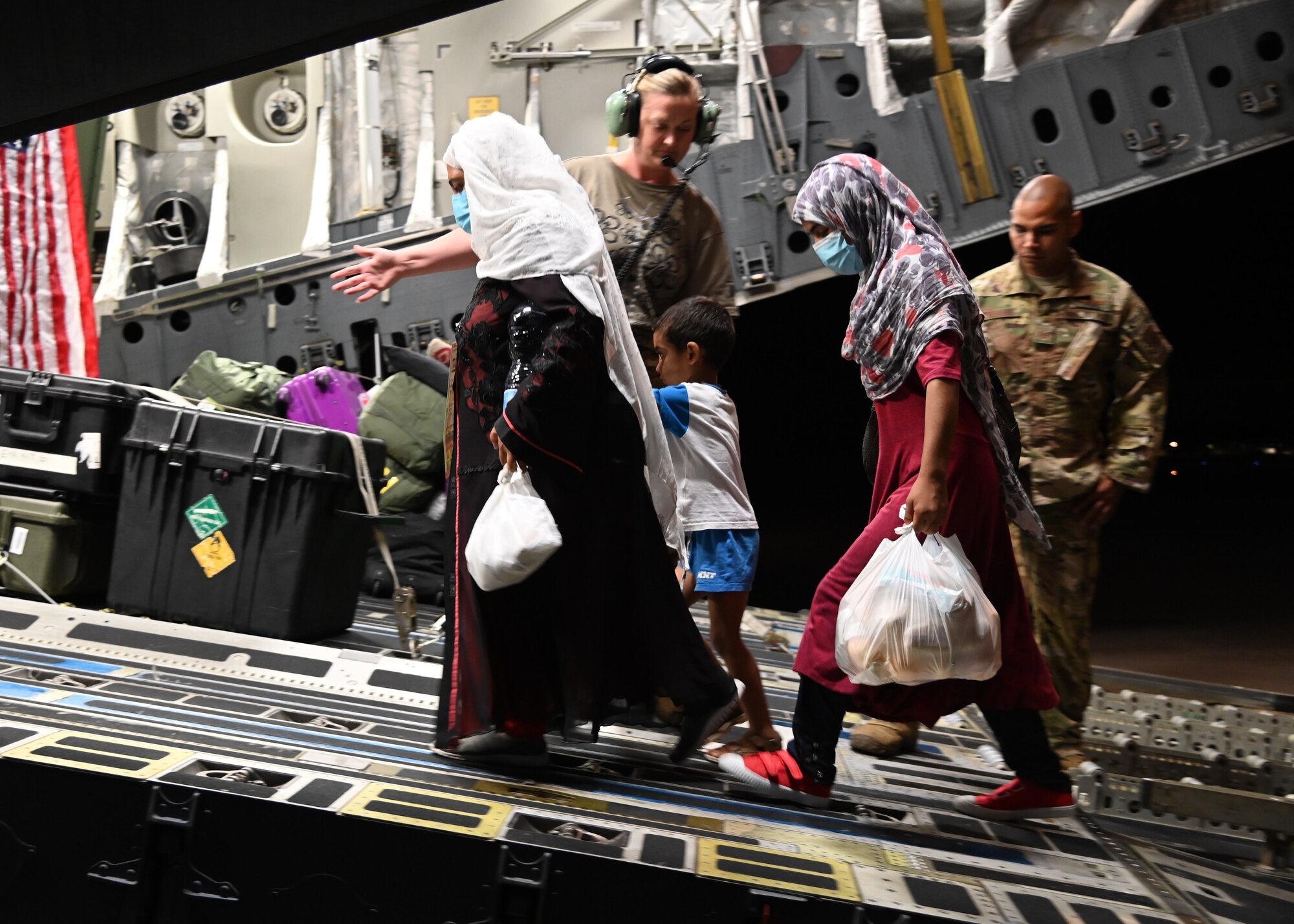 An evacuee from Afghanistan boards a U.S. Air Force C-17 Globemaster III during a medical evacuation from Naval Air Station Sigonella, Sept. 5, 2021. NAS Sigonella is supporting Department of State mission to facilitate the safe relocation of U.S. citizens, Special Immigration Visa recipients, and vulnerable populations from Afghanistan. (U.S. Navy photo by Mass Communication Specialist 1st Class Kegan E. Kay)