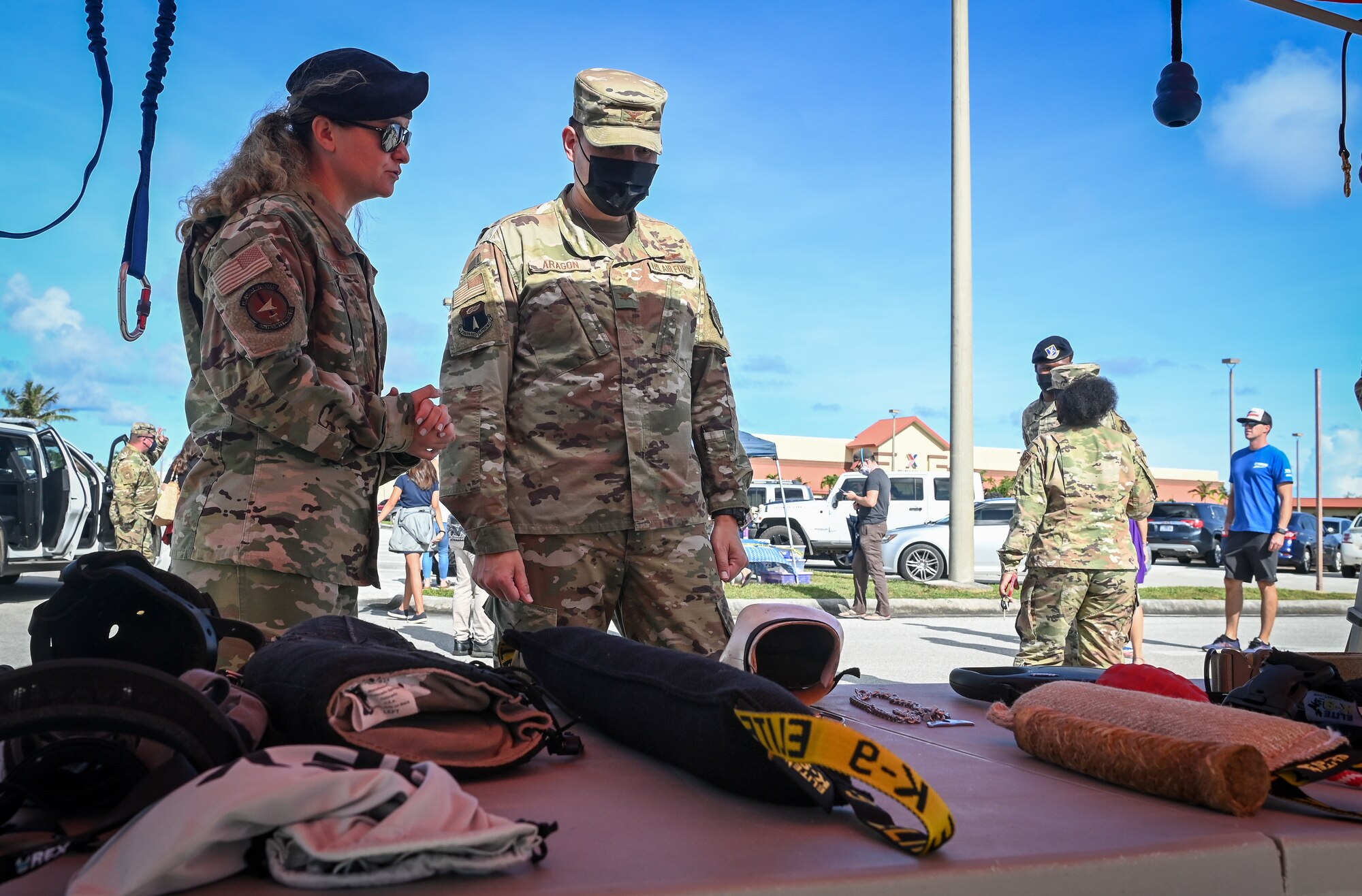U.S. Air Force Staff Sgt. Samantha Champion (left), dog handler assigned to the 36th Security Forces Squadron, briefs U.S Air Force Col. David Aragon (center), 36th Wing vice commander, during a military working dog demonstration at Andersen Air Force Base, Guam, Oct. 18, 2021.