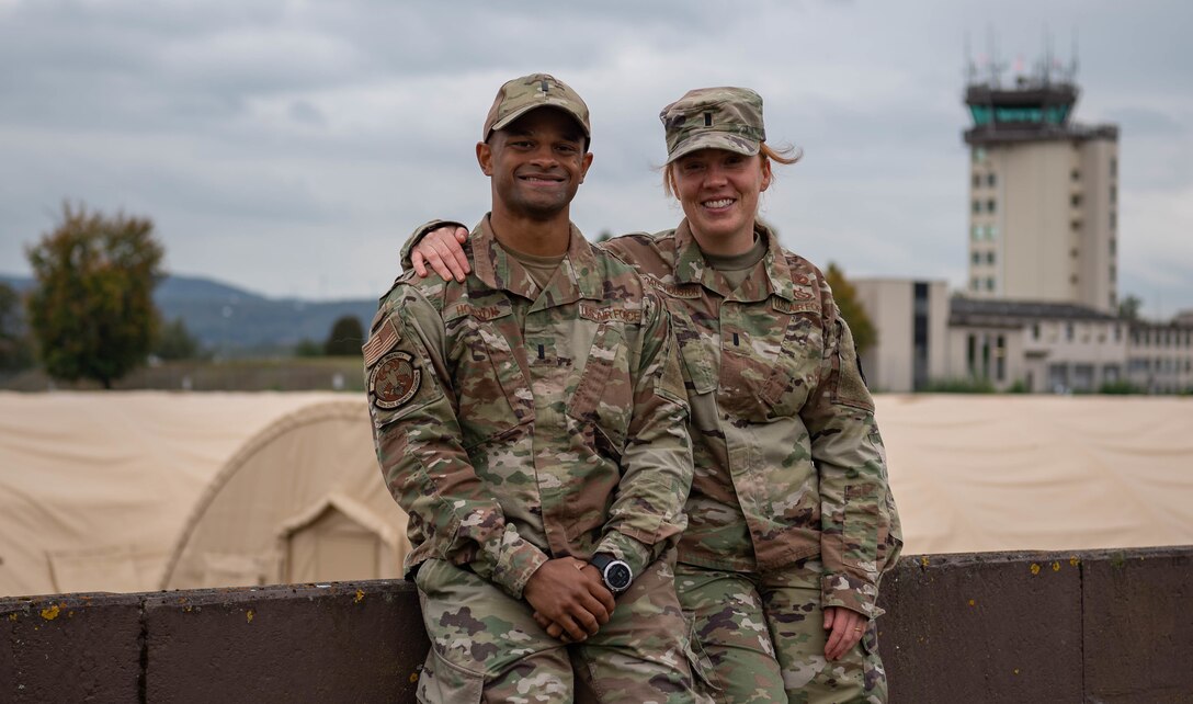 U.S. Air Force 1st Lt. Gabriel Houston, left, 786th Civil Engineer Squadron engineering chief, and 1st Lt. Merrick Choate-Houston, right, 86th CES Installation Management Flight deputy, were key players in the creation and sustainment of pod operations since the beginning of the Afghan evacuation operations at Ramstein Air Base, Germany, Oct. 12, 2021. The Houstons designed the blueprint for the buildup of the pods with short notice and ensured Airmen and contractors were able to sustain operations throughout the course of Operation Allies Welcome. (U.S. Air Force photo by Airman Jared Lovett)