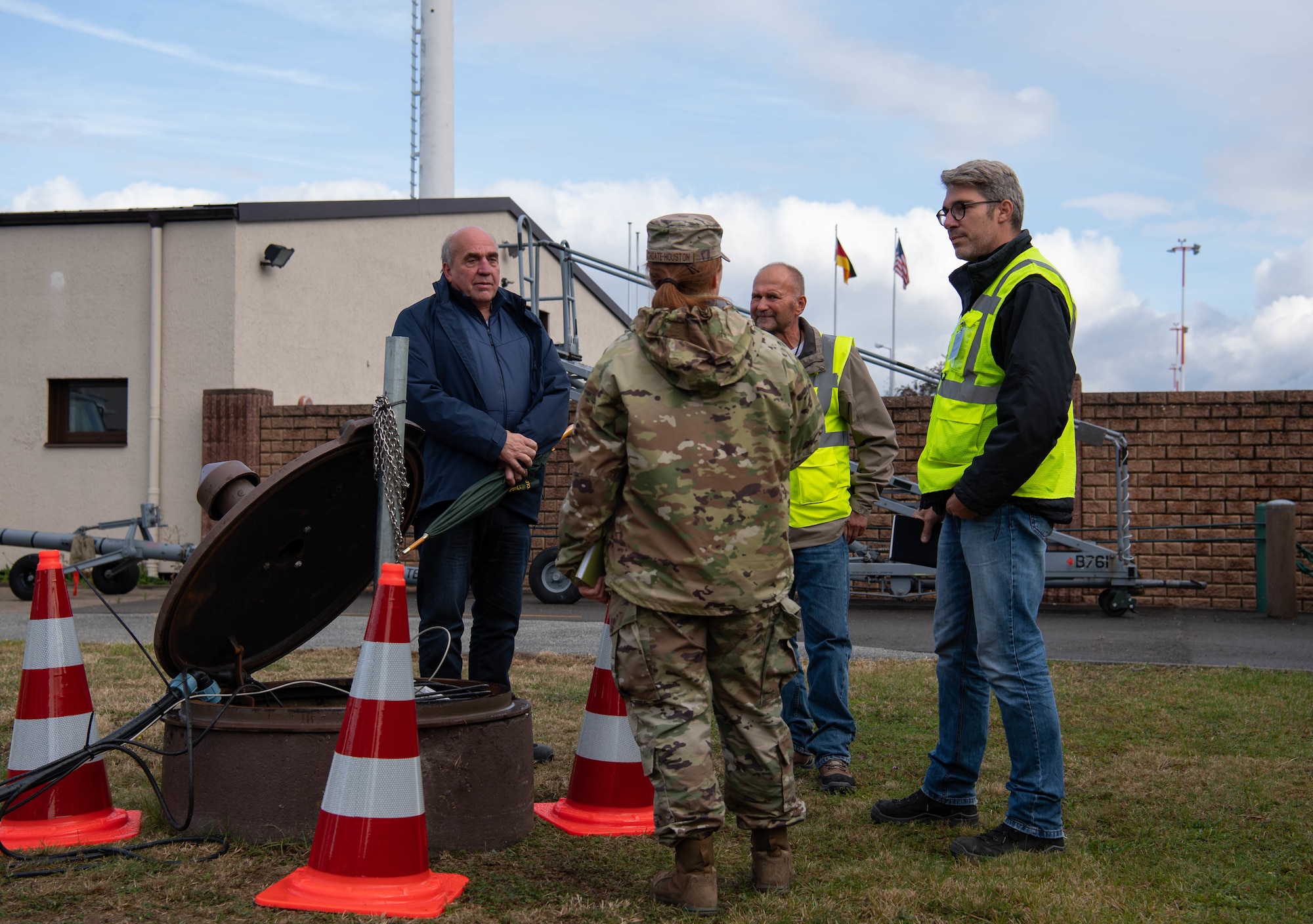 U.S. Air Force 1st Lt. Merrick Choate-Houston, 86th CES Installation Management Flight deputy, discusses cleaning an oil-water separator on Ramstein Air Base, Germany, Oct. 13, 2021. Choate-Houston is responsible for identifying, developing, implementing and executing all civil engineer requirements for the sustainment and reconstitution of pods through contracted means. (U.S. Air Force photo by Airman Jared Lovett)