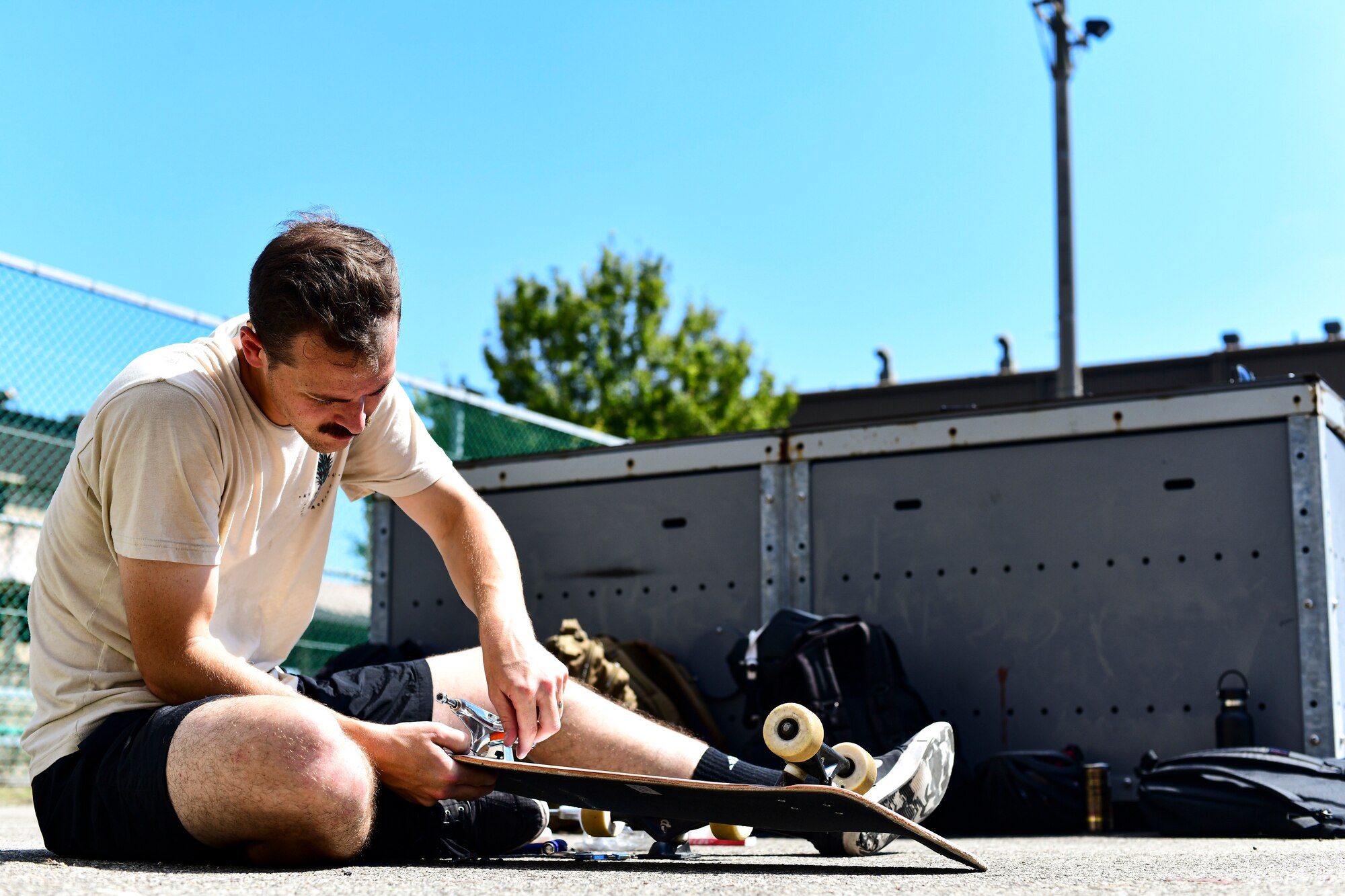 An Airman changes his trucks.