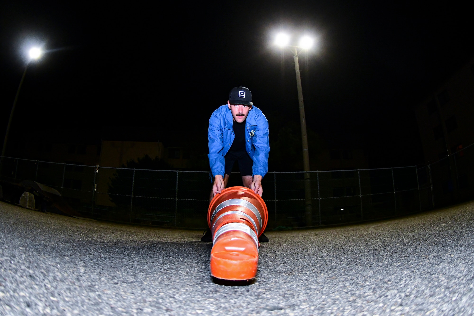 An Airman repositions a traffic cone.