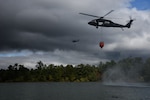 Virginia Army National Guard flight crews conduct water bucket training with UH-60 Black Hawk helicopters Oct. 12, 2021, at a training area in Chesterfield, Virginia. Aviation assets can support fire-fighting efforts with the use of water buckets, which require periodic training for flight crews in order to ensure equipment proficiency. These Soldiers are scheduled to deploy to Kosovo with the Sandston-based 2nd Battalion, 224th Aviation Regiment, 29th Infantry Division in early 2022, where fire-fighting capabilities may be needed. (U.S. Army National Guard photo by Sgt. 1st Class Terra C. Gatti)