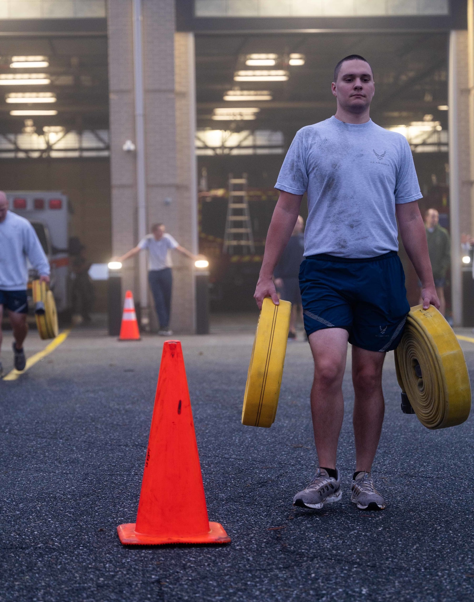 Senior Airman Carter Aldrich, 436th Civil Engineer Squadron structural journeyman, performs farmer carries during a physical training session at the firehouse on Dover Air Force Base, Delaware, Oct. 14, 2021. The Dover AFB fire department hosted a firefighter centric workout for squadron members that featured farmer carries, hose drags and ladder climbs, as part of Fire Prevention Week 2021. (U.S. Air Force photo by Senior Airman Faith Schaefer)