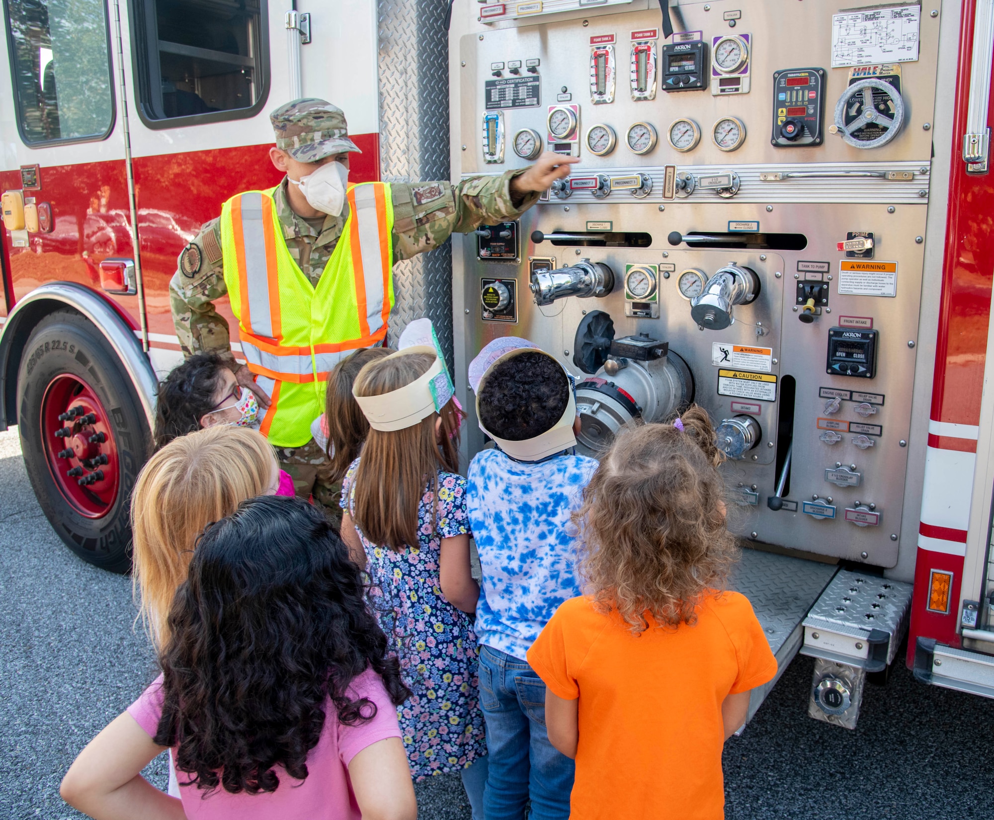 Senior Airman Kyle Spence, 436th Civil Engineer Squadron firefighter, shows students from Major George S. Welch Elementary School about the different gauges on a fire truck during a visit for Fire Prevention Week on Dover Air Force Base, Delaware, Oct. 15, 2021. Fire Prevention Week is an annual observance to educate the Dover AFB community about the importance of fire prevention. (U.S. Air Force photo by Tech. Sgt. Nicole Leidholm)