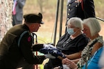 Col. Wes Morrison, commander of the North Carolina National Guard’s 30th Armored Brigade Combat Team, presents folded flags to the family of 1st Lt. James E. Wright during a graveside service in his honor at the Oakdale Cemetery in Lumber Bridge, North Carolina, Oct. 12, 2021. Wright, who served with the NCNG’s 120th Infantry Regiment, was killed in action near Dornot, France Sept. 10, 1944, and missing until his remains were recently identified.