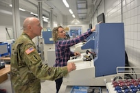 Yvonne Gortner, prescription eyeglass maker supervisor for the U.S. Army Medical Materiel Center-Europe, examines a custom lens to make certain it is correctly ground. Gortner has been with USAMMCE since 2003, beginning as an optician.
