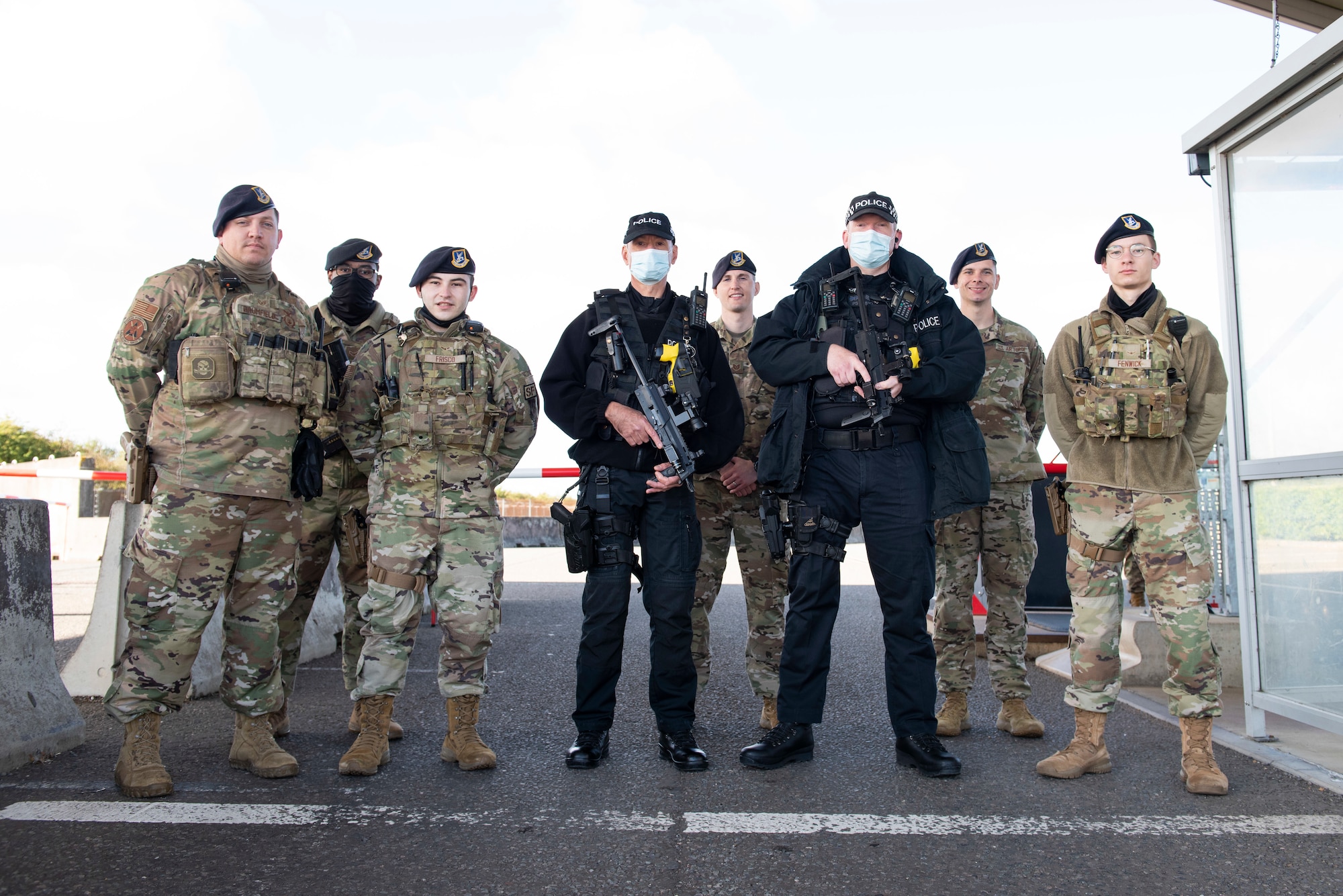 U.S. Air Force Airmen from the 423rd Security Forces Squadron pose for a group photo with the Ministry of Defence police at Royal Air Force Molesworth, England, Sept. 29, 2021. The AFIMSC leadership visited the 501st Combat Support Wing and its mission partners at the U.S. European Command Joint Intelligence Operations Center Europe Analytic Center at RAF Molesworth, England. The AFIMSC provides base communications, civil engineering, security forces and logistics support that assist the 501st CSW in fulfilling its mission. (U.S. Air Force photos by Senior Airman Jennifer Zima)