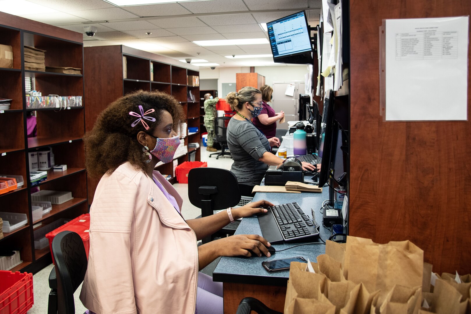 Pharmacy Technicians serving aboard Naval Health Clinic Cherry Point enter patient information Thursday, October 14 in the clinic’s Pharmacy.  Staff in the department credit their teamwork and eagerness to share success to deliver the best patient care possible.