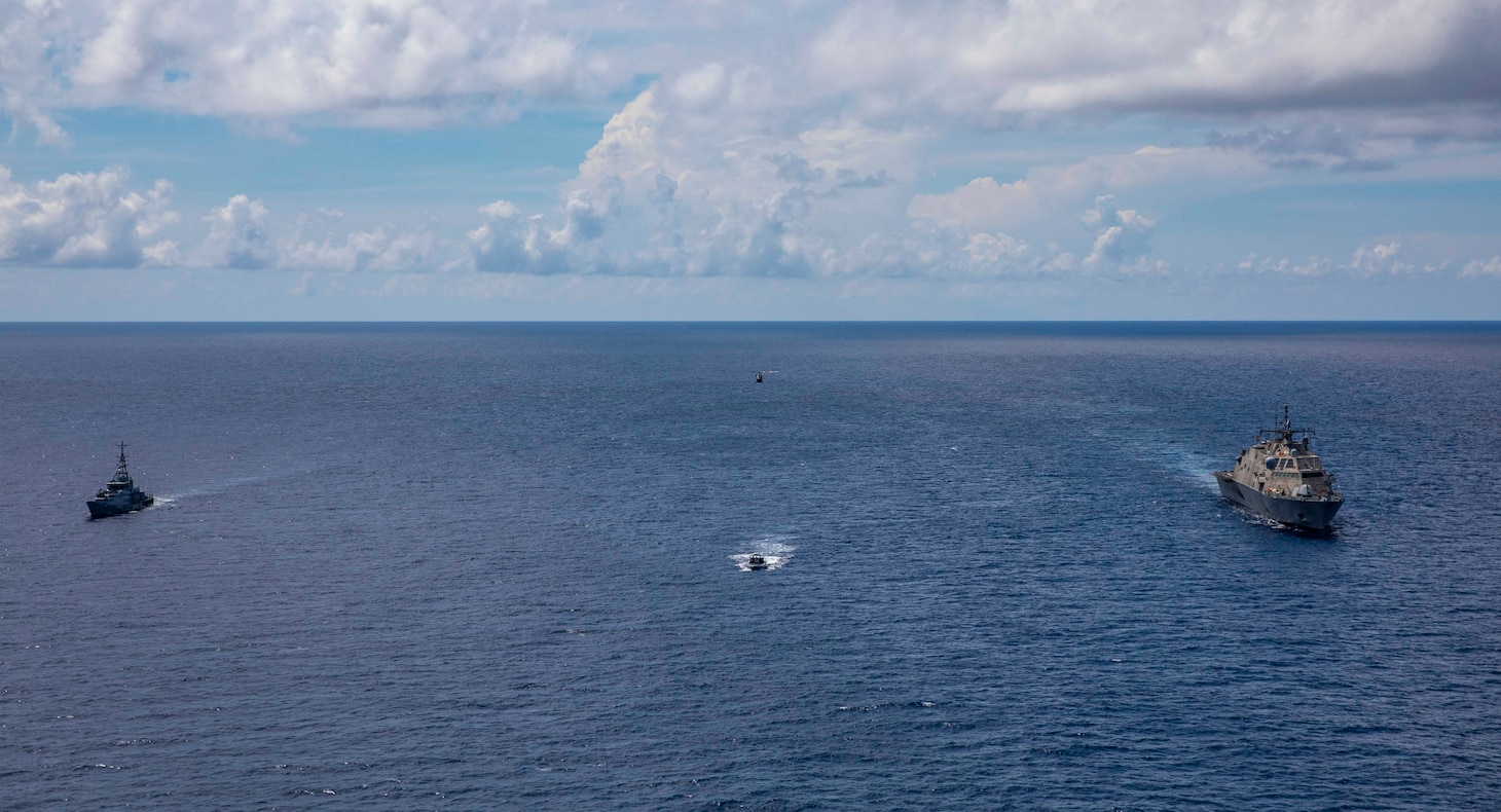 The Freedom-variant littoral combat ship USS Billings (LCS 15) and its rigid-hull inflatable boat (RHIB) conduct a bilateral maritime exercise with the Jamaica Defense Force (JDF) Coast Guard patrol vessel HMJS George William Gordon and its embarked helicopter detachment, , Oct. 16, 2021.