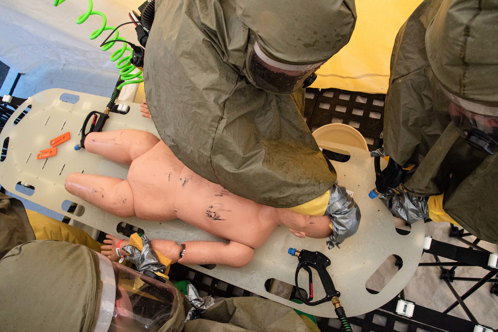 Sailors serving aboard Naval Health Clinic Cherry Point decontaminate a simulated patient while conducting a practical exercise demonstrating their proficiency Thursday, October 14 aboard Marine Corps Air Station Cherry Point.  Sailors assigned to the clinic participated in a multi-day training program to sharpen their skills at safely removing hazardous materials from patients.