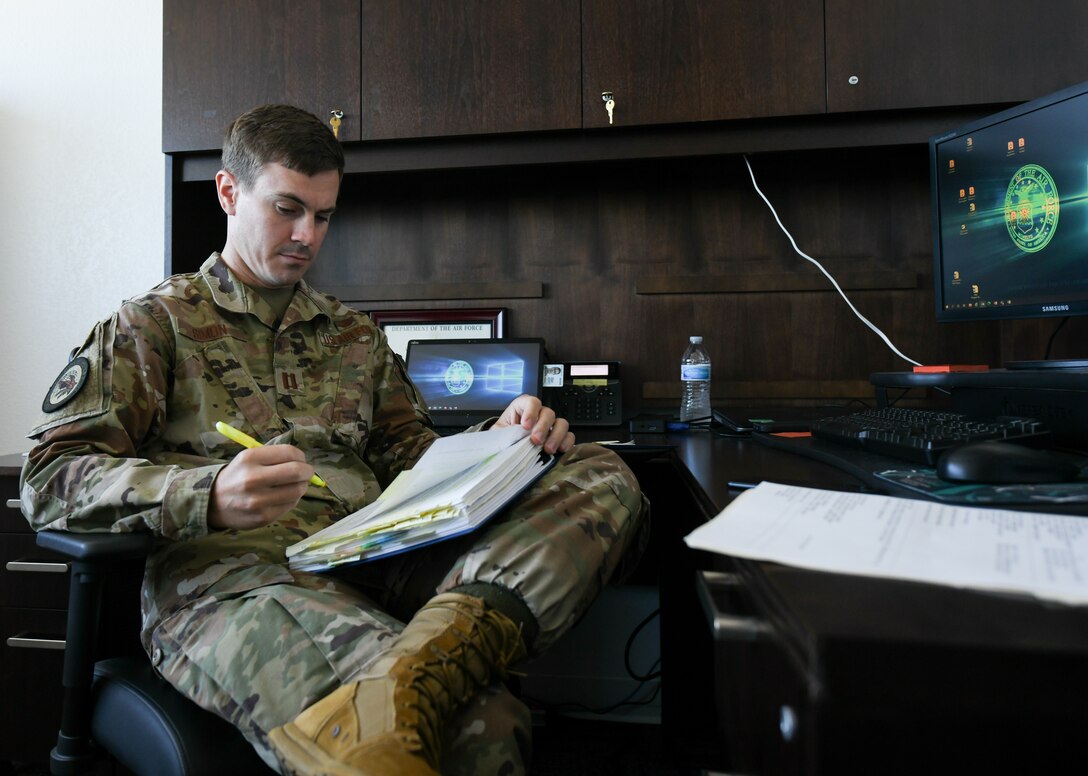 U.S. Air Force Capt. Peter Simon, Headquarters Air Force special victim’s council attorney, highlights important information in case files at Tyndall Air Force Base, Florida, Sept. 27, 2021. SVC teams, consisting of an attorney and paralegal, are assigned to various bases across the Air Force, but answer to HAF rather than a unit or installation commander. (U.S. Air Force Photo by Airman 1st Class Anabel Del Valle)