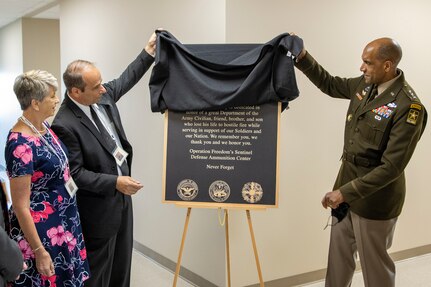 Lt. Gen. Gary M. Brito, U.S. Army Deputy Chief of Staff, G-1, right, and unveils a memorial plaque with the parents of Michael G. Sauro, a former Defense Ammunition Center hazardous material instructor who lost his life while deployed as a civilian in support of Operation Freedom’s Sentinel, during a building dedication ceremony at Camp Atterbury, Ind., June 3, 2021. Sauro’s mother, Christine Sauro, left, and father, Michael E. Sauro, were on-hand to help dedicate Building 444 on the installation to their son. (U.S. Army photo by Mark R. W Orders-Woempner)