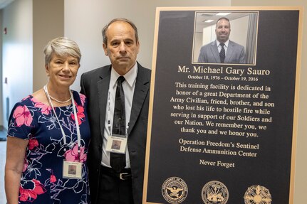 Michael E. Sauro and Christine Sauro, the parents of Michael G. Sauro, a former Defense Ammunition Center hazardous material instructor who lost his life while deployed as a civilian in support of Operation Freedom’s Sentinel, pose for a photo during a building dedication ceremony at Camp Atterbury, Ind., June 3, 2021. Sauro’s mother, Christine Sauro, left, and father, Michael E. Sauro, were on-hand to help dedicate Building 444 on the installation to their son. Sauro was one of four Army civilian employees who lost their lives in service to their country while deployed and had buildings on the installation named after them during the day’s events. (U.S. Army photo by Mark R. W Orders-Woempner)