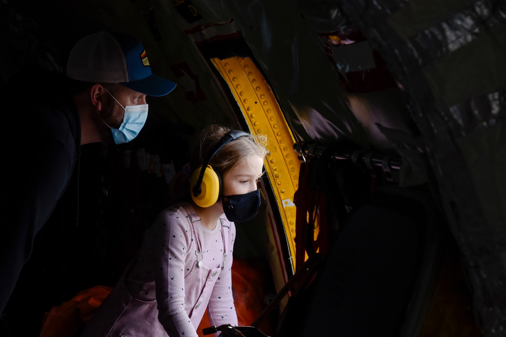 A young girl and her father peer out the window of a KC-135 Stratotanker static display during “The Sky’s No Limit: Girls Fly Too” event in Abbotsford, Canada, Oct. 3, 2021. The event gave Airmen from Fairchild an opportunity to empower young ladies, and inspire them to pursue various career opportunities. (U.S. Air Force photo by 2nd Lt. Michelle Chang)