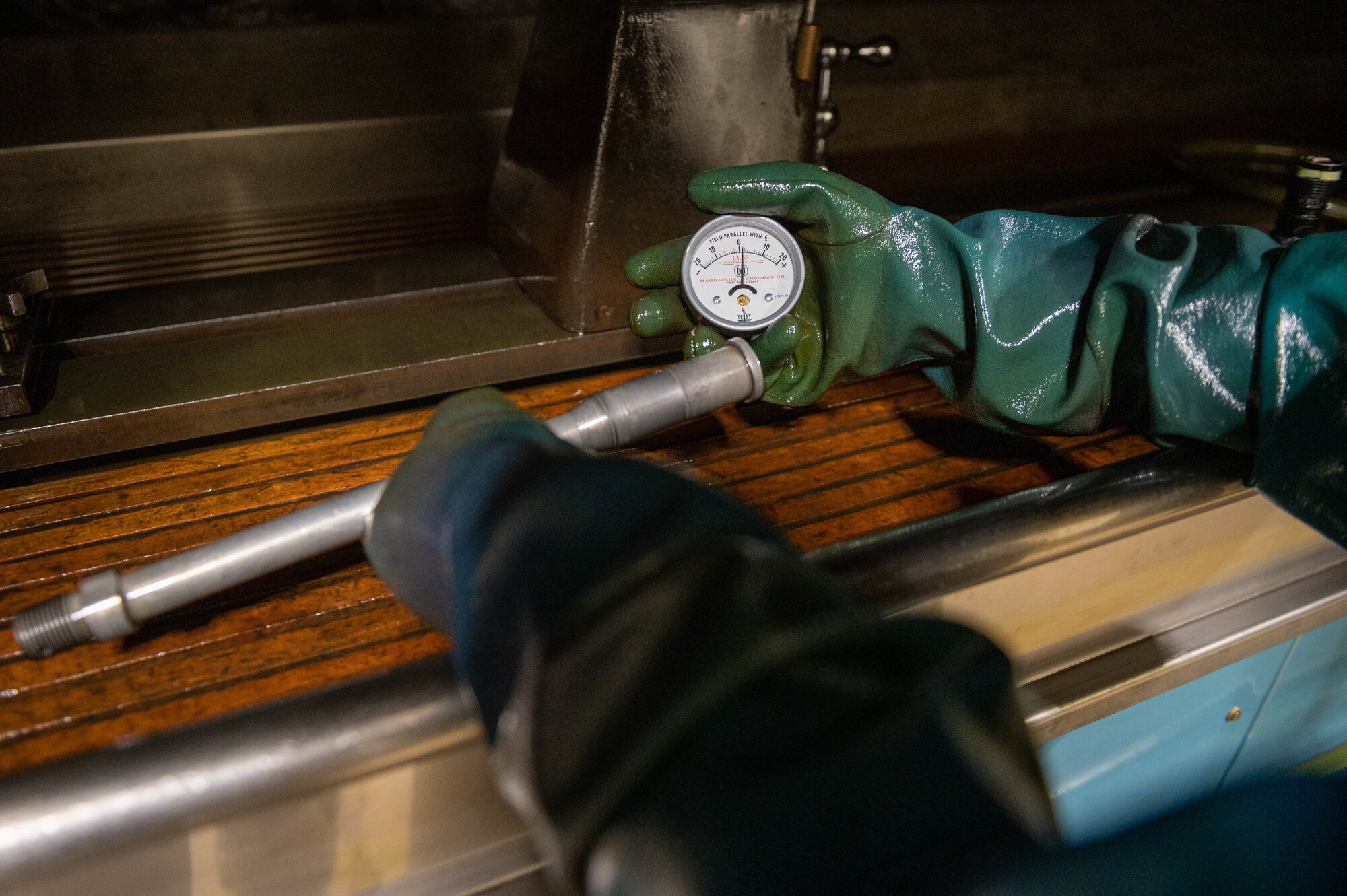 Technician holds a field test indicator next to a boom fork shaft.