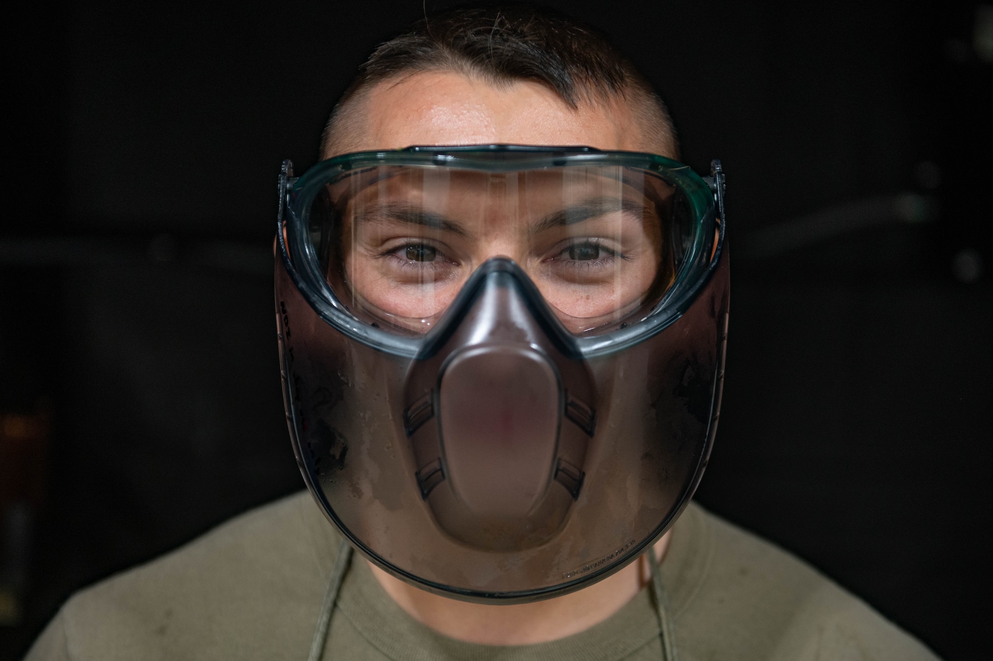 Portrait of a nondestructive inspection technician with a face shield on.