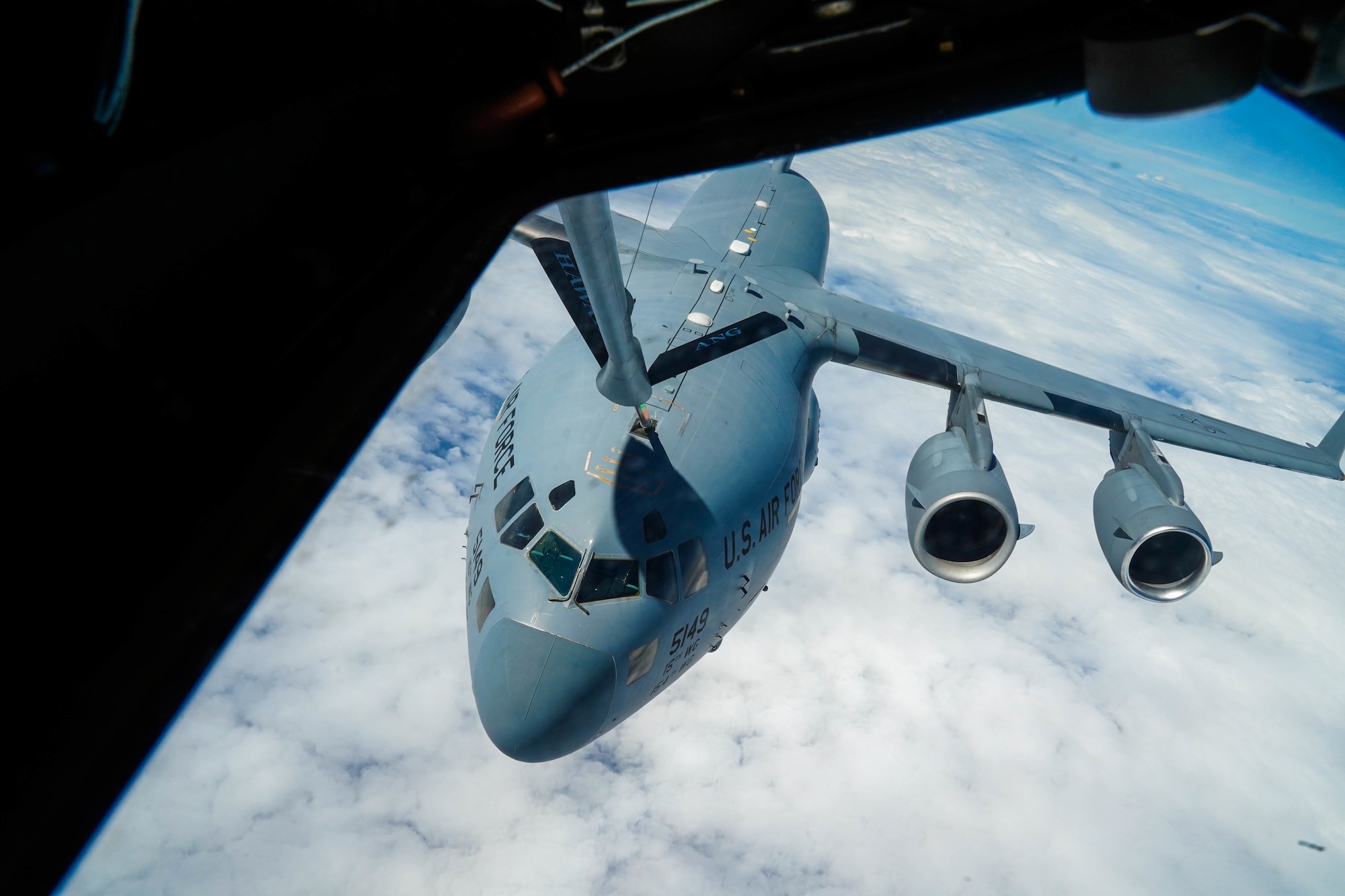 An U.S. Air Force C-17 Globemaster III from the 535th Airlift Squadron prepares to be refueled by a KC-135 Stratotanker in the airspace around Hawaii, October 18, 2021. The C-17 can perform tactical airlift and airdrop missions and can transport litters and ambulatory patients during aeromedical evacuations. (U.S Air Force photo by Airman 1st Class Makensie Cooper)