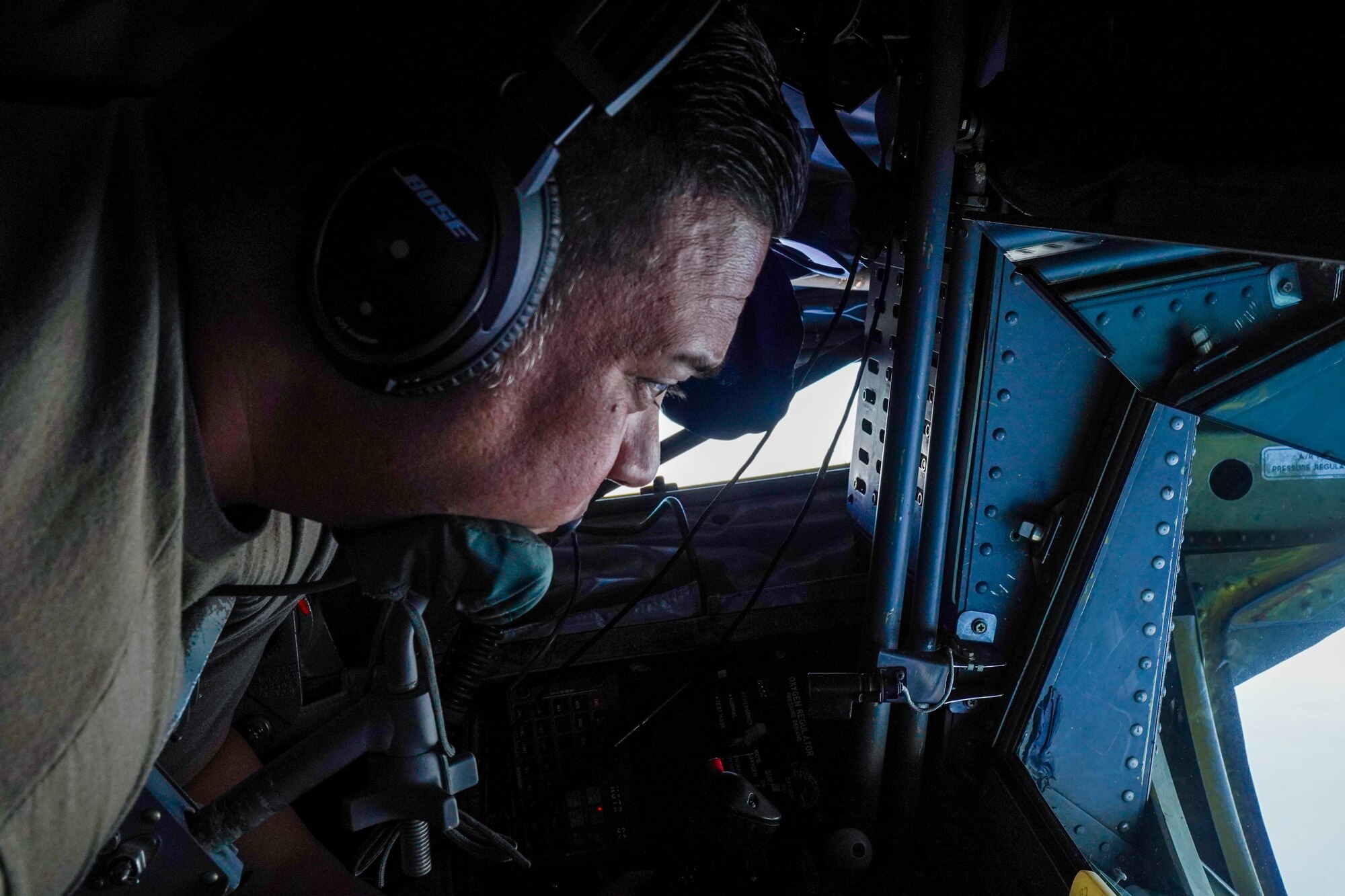 Master Sgt. Cal Codeiro, 203d Airlift Squadron, boom operator, refuels a C-17 Globemaster III during a refueling exercise in the airspace around Hawaii, October 18, 2021. The boom operator is stationed in the rear of the fuselage operating a boom to refuel aircraft in flight. (U.S. Air Force photo by Airman 1st Class Makensie Cooper)