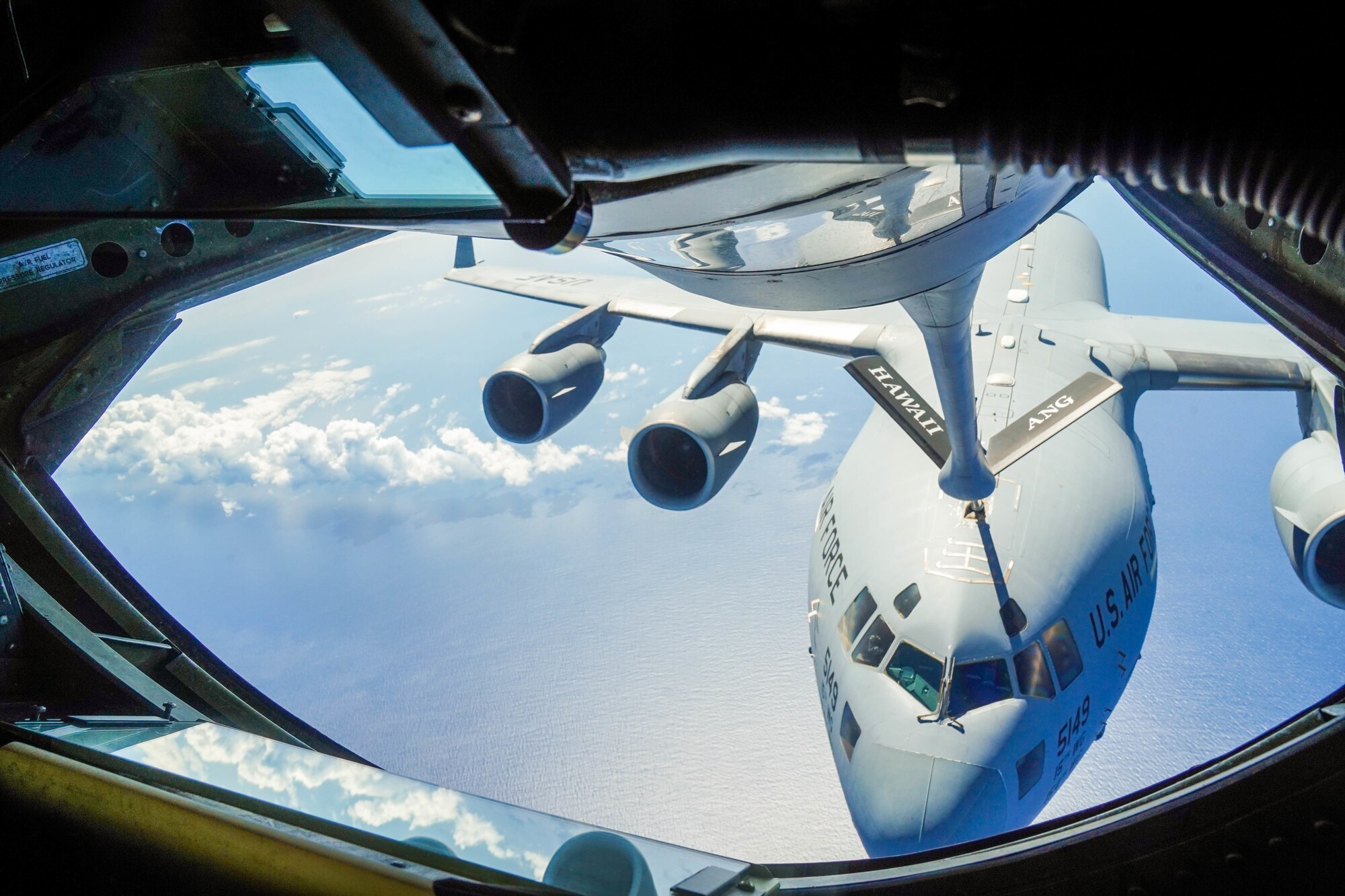 A KC-135 Stratotanker refuels a C-17 Globemaster III during an aerial refueling exercise around  Hawaiian Islands, October 18, 2021. The C-17 is capable of rapid strategic delivery of troops and all types of cargo to main operating bases or directly to forward bases in the deployment area.  (U.S Air Force photo by Airman 1st Class Makensie Cooper)