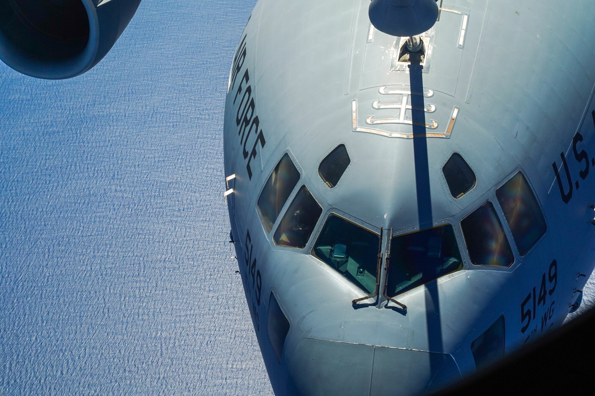 A KC-135 Stratotanker refuels a C-17 Globemaster III from the 535th Airlift Squadron during an aerial refueling exercise around  Hawaiian Islands, October 18, 2021. The C-17 can perform tactical airlift and airdrop missions and can transport litters and ambulatory patients during aeromedical evacuations. (U.S Air Force photo by Airman 1st Class Makensie Cooper)