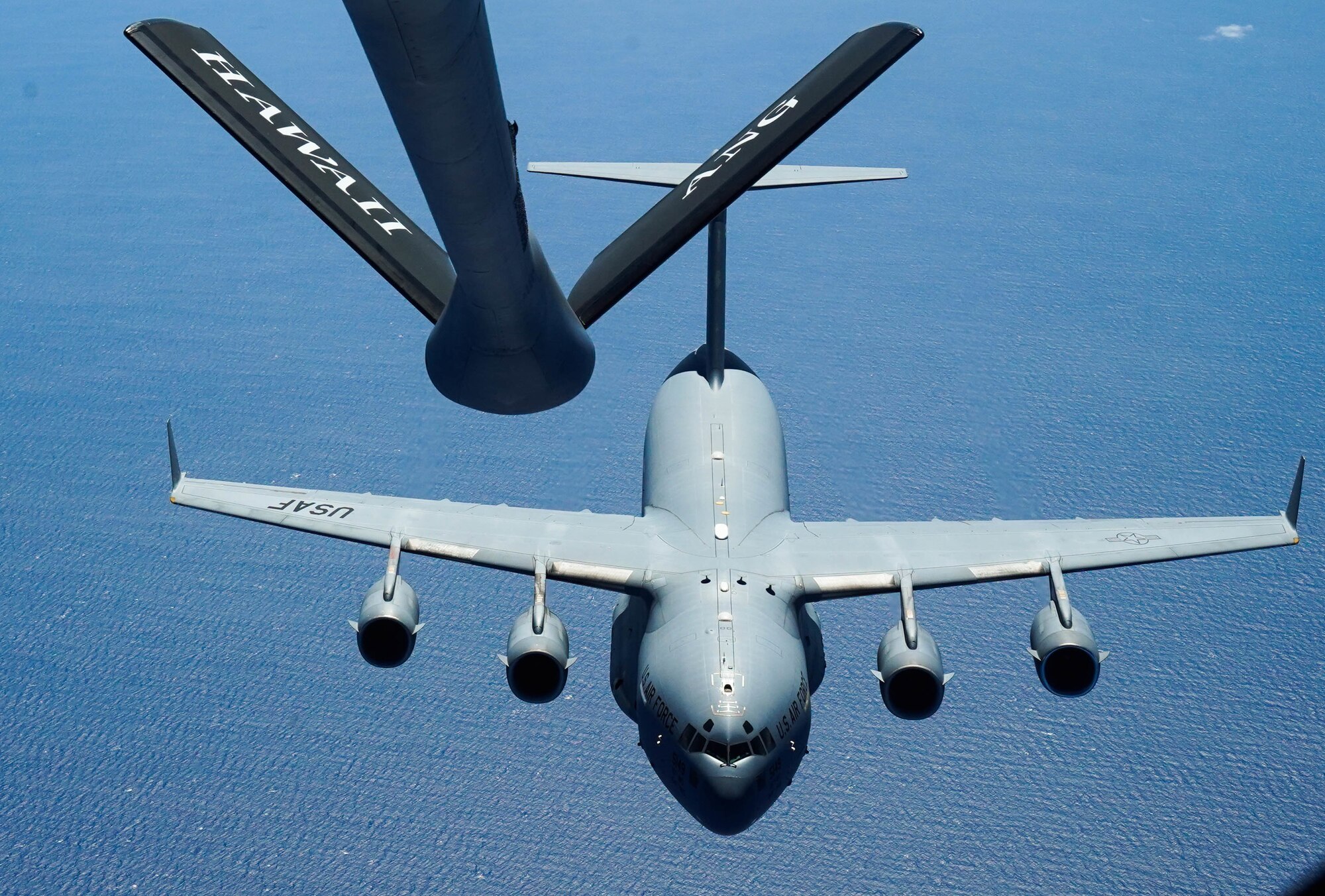 A KC-135 Stratotanker refuels a C-17 Globemaster III from the 535th Airlift Squadron during an aerial refueling exercise around  Hawaiian Islands, October 18, 2021. The C-17 is capable of rapid strategic delivery of troops and all types of cargo to main operating bases or directly to forward bases in the deployment area.  (U.S Air Force photo by Airman 1st Class Makensie Cooper)