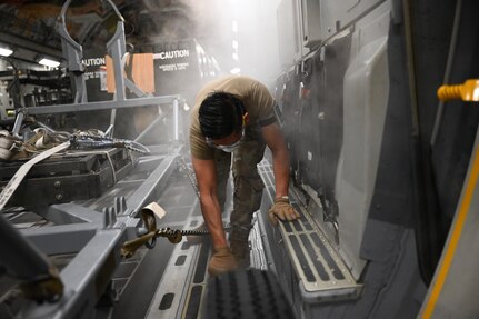 Photo of U.S. Airman working inside aircraft