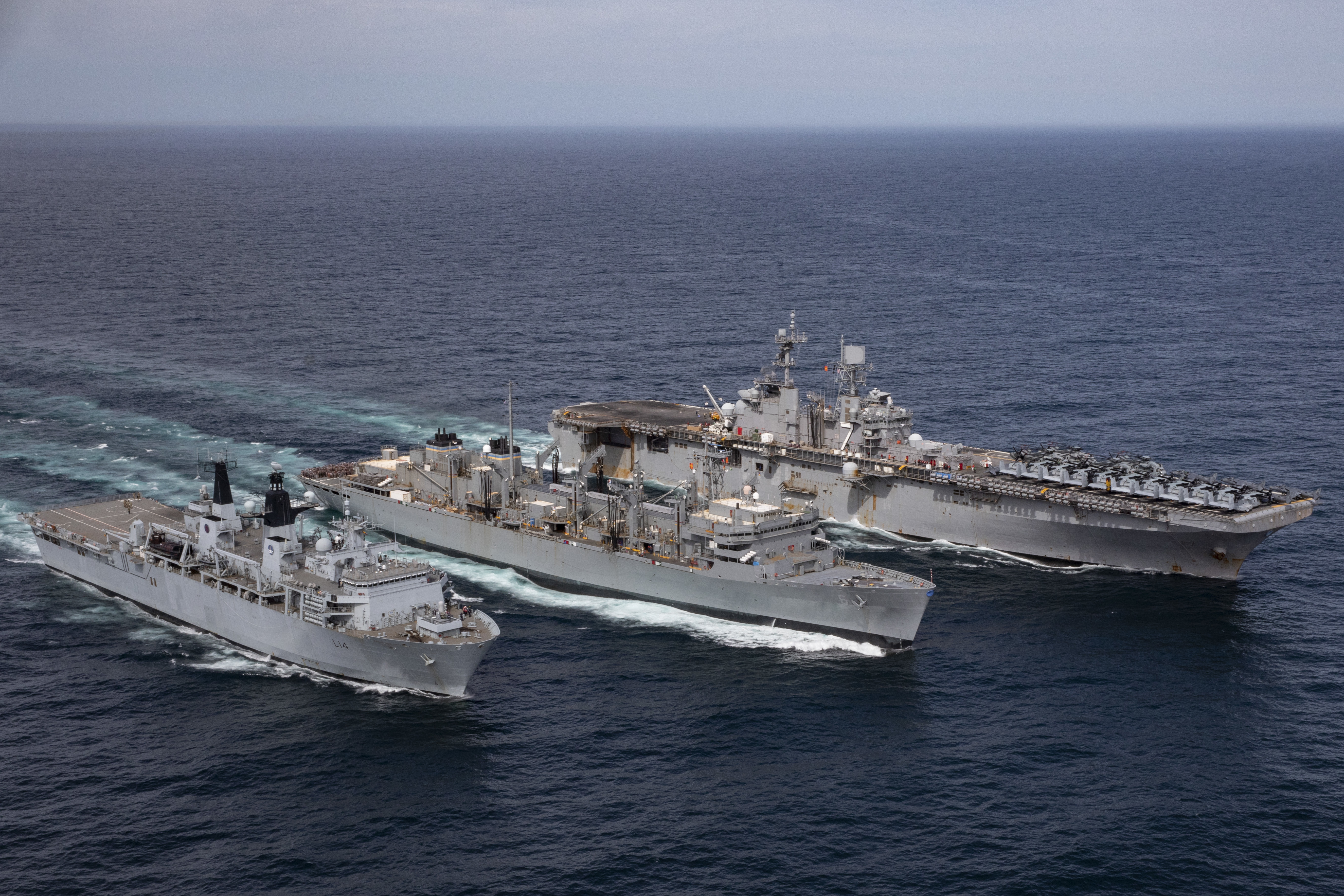 NORTH SEA (May 9, 2021) The Wasp-class amphibious assault ship USS Iwo Jima (LHD 7), right, the fast combat support ship USNS Supply (T-AOE 6) and the Royal Navy landing platform dock ship HMS Albion (L 14) conduct a replenishment-at-sea, May 9, 2021. Iwo Jima is operating in the Atlantic Ocean with Amphibious Squadron 4 and the 24th Marine Expeditionary Unit (24th MEU) as part of the Iwo Jima Amphibious Ready Group. (U.S. Navy photo by Mass Communication Specialist 3rd Class Jessica Kibena)