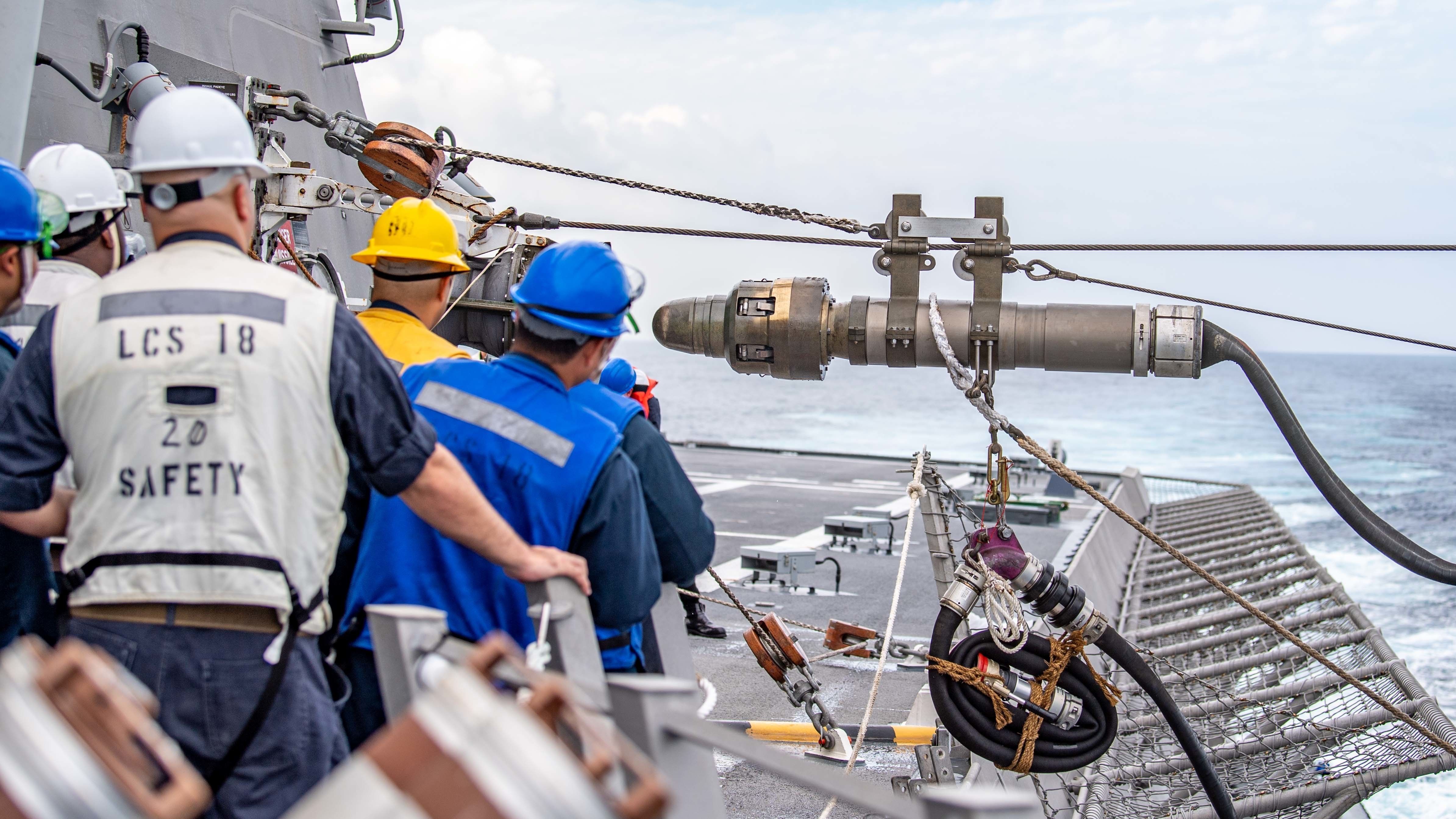 Sailors assigned to Independence-variant littoral combat ship USS Charleston (LCS 18), await the setting of the fuel probe during an underway replenishment with Fleet replenishment Oiler USNS Big Horn (T-AO 198).