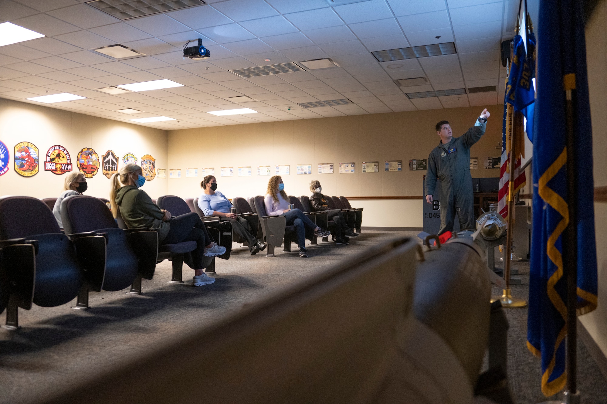 An airman gives a briefing to an audience