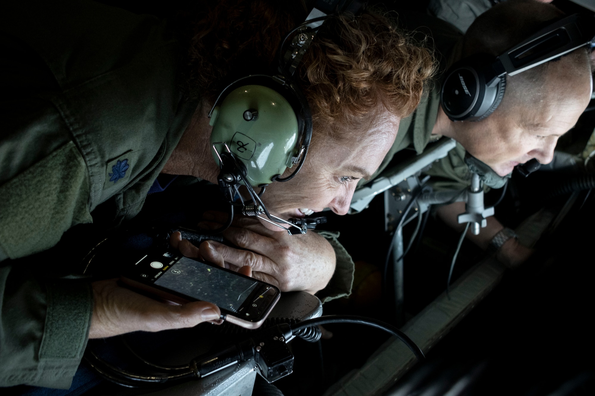 Two people watch a B-52 get refueled