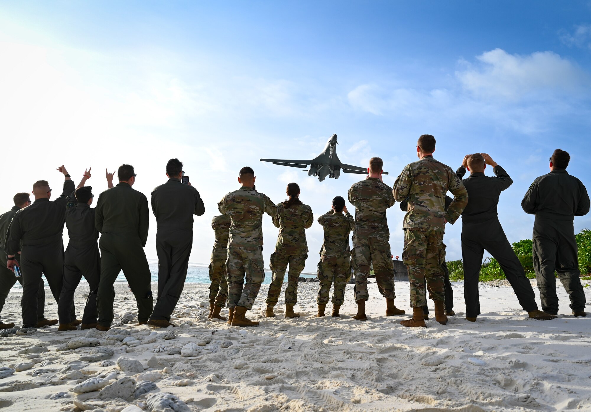 Photo of U.S. Air Force B-1 Lancer aircraft flying over Airmen