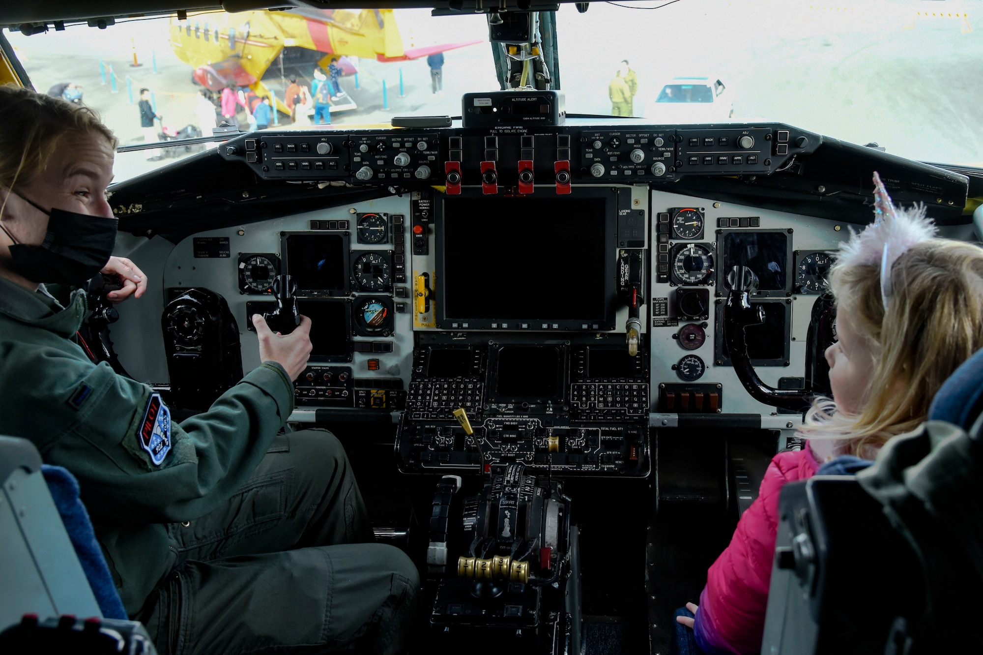 United States Air Force 1st Lt. Elizabeth Denton, 92nd Air Refueling Squadron KC-135 Stratotanker pilot, shows a young girl the inside of a KC-135 flight deck during “The Sky’s No Limit: Girls Fly Too” event in Abbotsford, Canada, Oct. 3, 2021. The event gave Airmen from Fairchild an opportunity to empower young ladies, and inspire them to pursue various career opportunities. (U.S. Air Force photo by 2nd Lt. Michelle Chang). (U.S. Air Force photo by 2nd Lt. Michelle Chang)