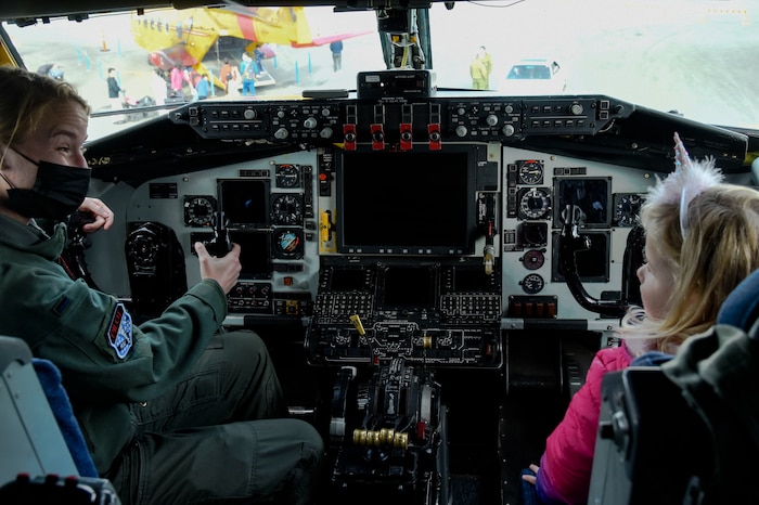 United States Air Force 1st Lt. Elizabeth Denton, 92nd Air Refueling Squadron KC-135 Stratotanker pilot, shows a young girl the inside of a KC-135 flight deck during “The Sky’s No Limit: Girls Fly Too” event in Abbotsford, Canada, Oct. 3, 2021. The event gave Airmen from Fairchild an opportunity to empower young ladies, and inspire them to pursue various career opportunities. (U.S. Air Force photo by 2nd Lt. Michelle Chang). (U.S. Air Force photo by 2nd Lt. Michelle Chang)