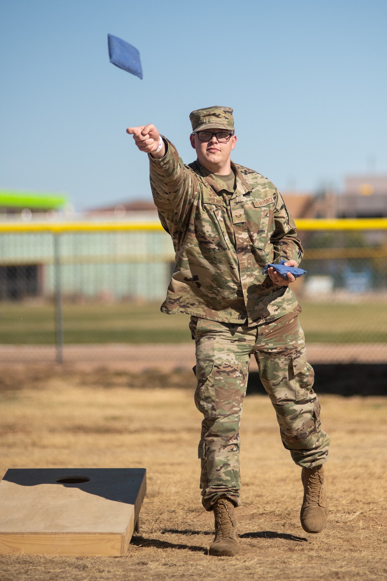 Person playing cornhole.