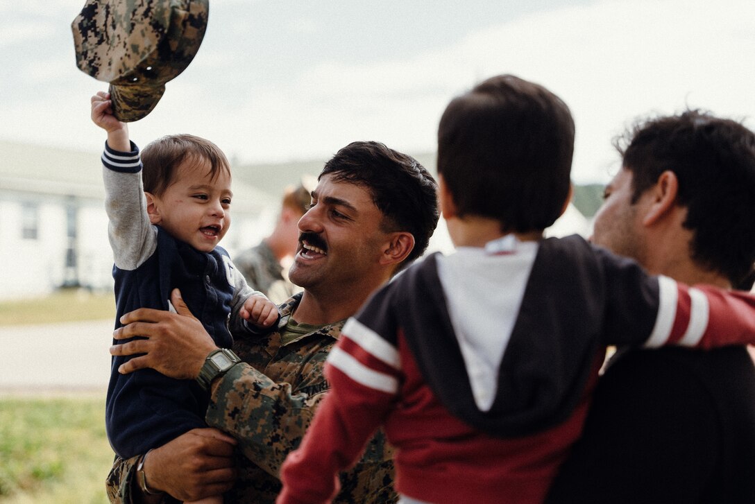 U.S. Marine Corps Lance Cpl. Nima H. Najafabadi , a machine gunner with 3rd Battalion, 6th Marine Regiment, plays with an Afghan child on Fort Pickett, Virginia, Oct. 13, 2021. Najafabadi, originally from Shiraz, Iran, came to the United States when he was 8 years old. Now, he is grateful for the opportunity to help families who are in a similar position that he was in 20 years ago. The Department of Defense, through U.S. Northern Command, and in support of the Department of Homeland Security, is providing transportation, temporary housing, medical screening, and general support for at least 50,000 Afghan evacuees at suitable facilities, in permanent or temporary structures, as quickly as possible. This initiative provides Afghan personnel essential support at secure locations outside Afghanistan. (U.S. Marine Corps photo by Sgt. Corey Mathews)