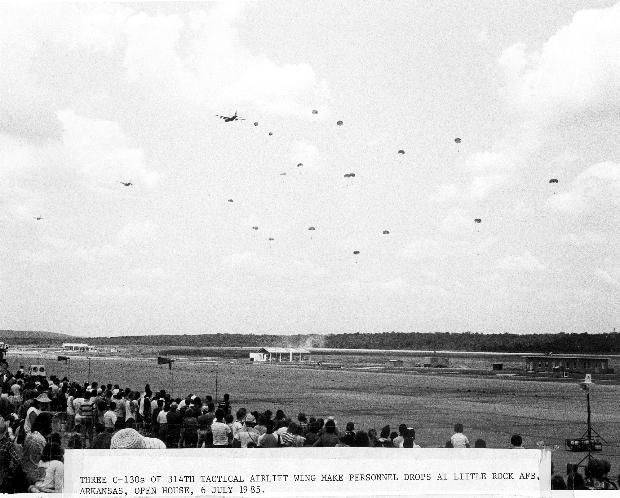 C-130s conduct an airdrop during an airshow