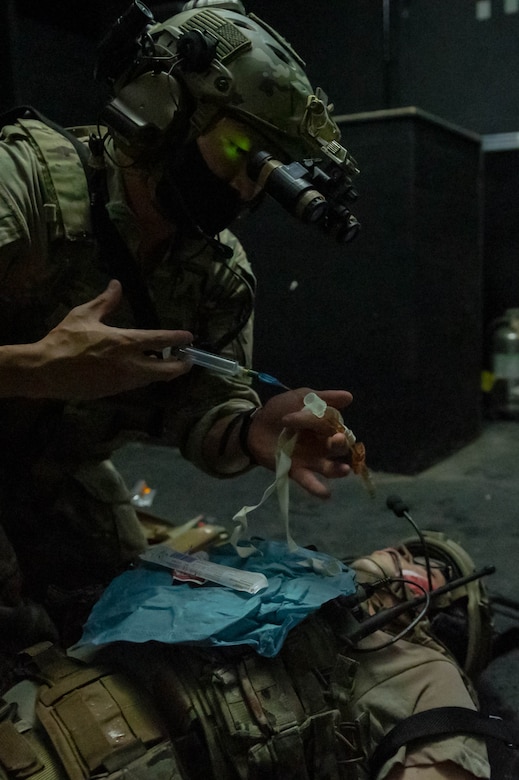 Soldier holds a syringe.