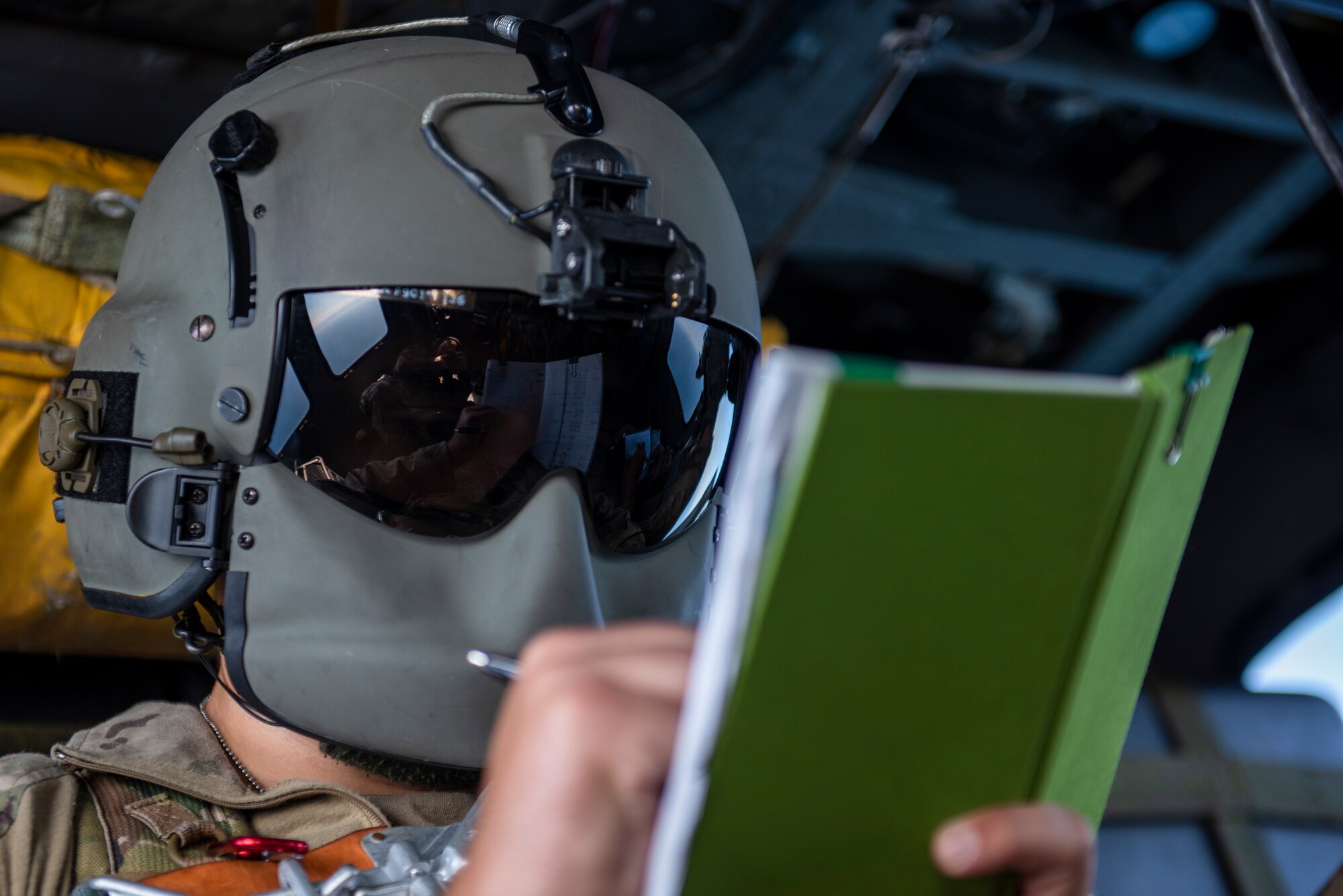 Senior Airman Eaven Allison, 33rd Rescue Squadron special missions aviator, takes notes during a combat search and rescue training event