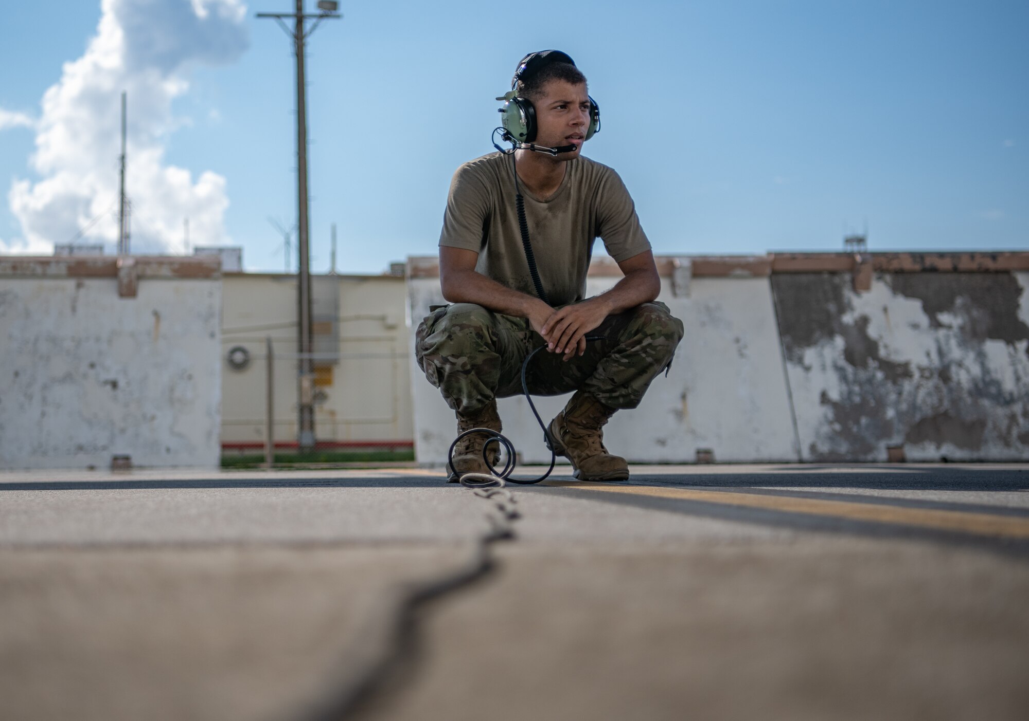 An Airman talks on a headset.