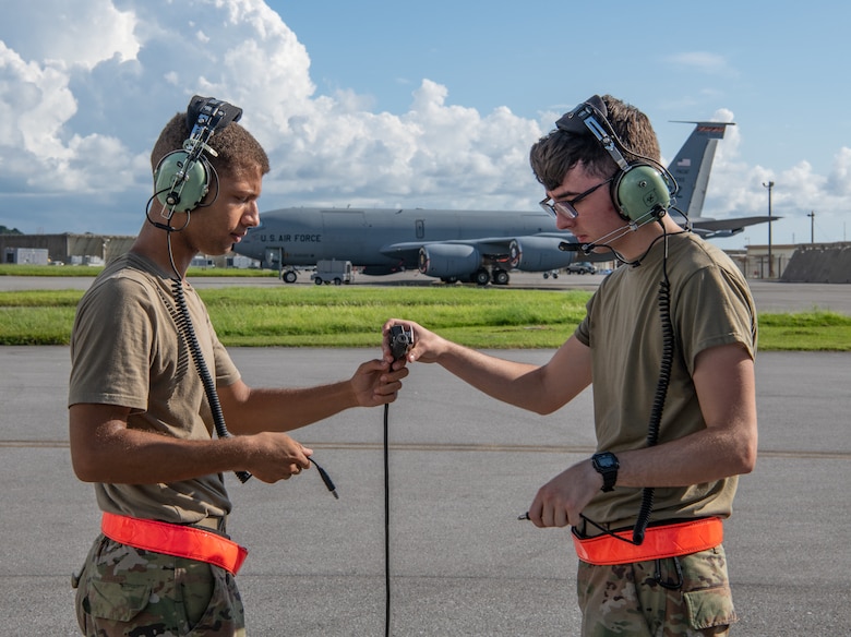 An Airman hands the communication cord to another Airman.