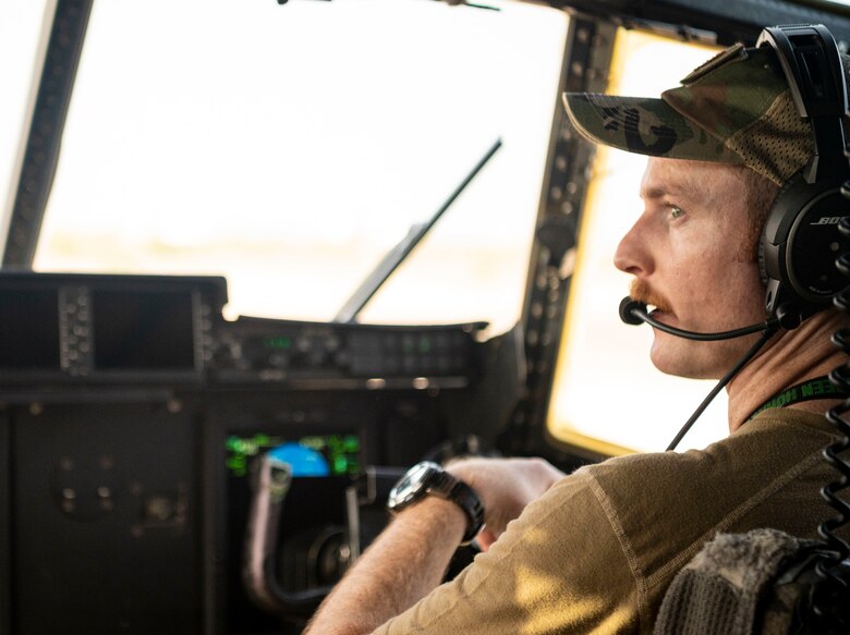 An Airman conducts a pre-flight check of a C-130J