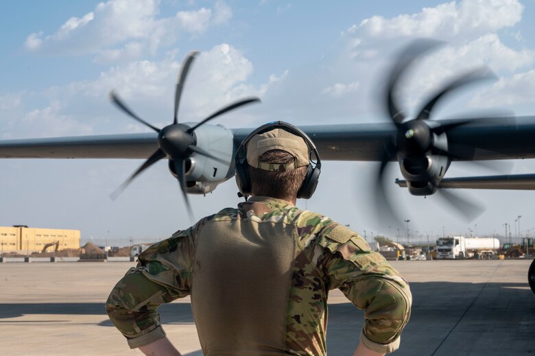 An Airman conducts a pre-flight check of a C-130J